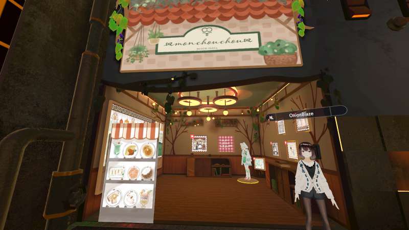 Musubi Panya’s booth, with a 3D avatar beside it. Food illustrations and comfy drawings can be seen.