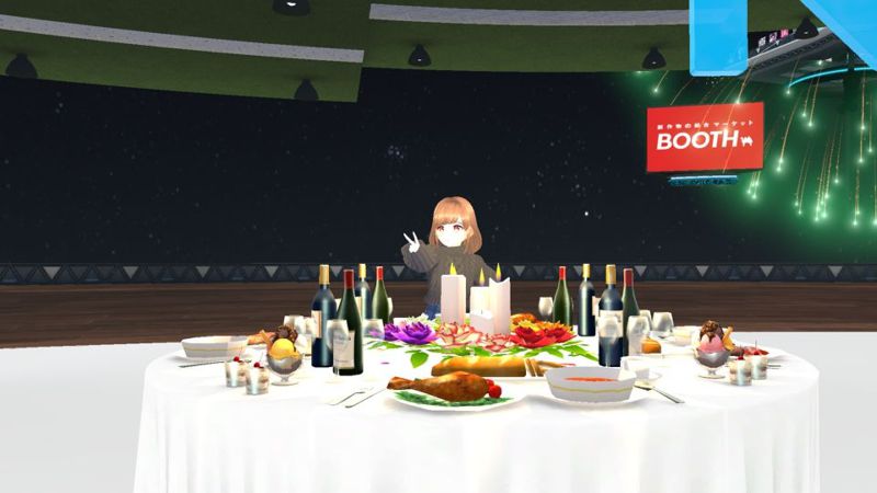 A girl doing a peace sign. A table filled with food and drinks is in front of her, along with some fireworks in the background.